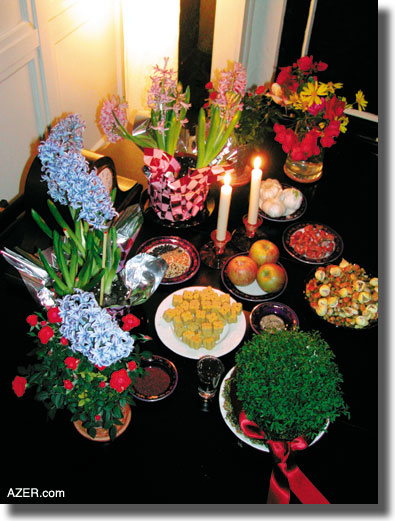 A Novruz table prepared by Narges Abadi in the tradition of Azerbaijanis from Iran. The traditional table includes at least seven items that start with the Persian letter "sin" (s). These include sabzi (sprouted grain), seeb (apple), serke (vinegar), somakh (a lemon-flavored spice for meat), sir (garlic), sonbol (hyacinth), senjed (a dry date-like fruit), saat (clock), and sekke (coins). The traditional table may also include candles, goldfish, colored eggs, mirror, sweets, flowers, dried fruit and nuts. Los Angeles.  Betty Blair
