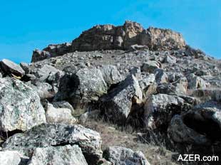 At first glimpse, it just looks like a rocky, typical landscape but closer study reveals evidence of Early Man. Gray Mountain outside of Baku.