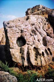This stone was probably lying horizontal in the past, but then fell on its side. Some holes are large enough to hold a sufficient amount of water. Other holes cannot yet be explained. Myriad questions remain. 