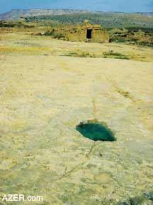 Gobustan-Gizildash region. Foreground may have been water collection system from the Bronze Age. The background shows a cistern that possibly dates to the Silk Road era.